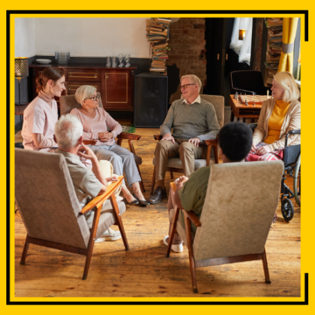 Caregiver entertaining a group of nursing or care home residents.